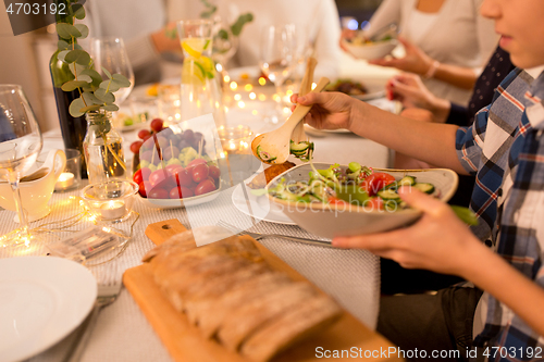 Image of happy family having dinner party at home