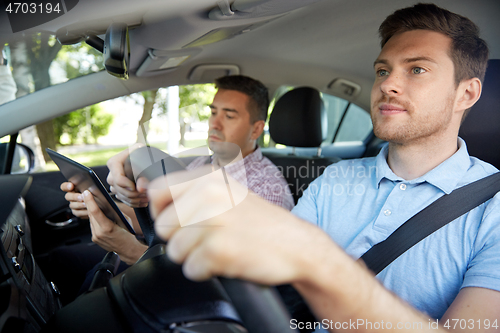 Image of car driving school instructor and young driver