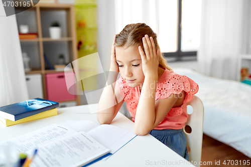 Image of sad student girl with notebook at home