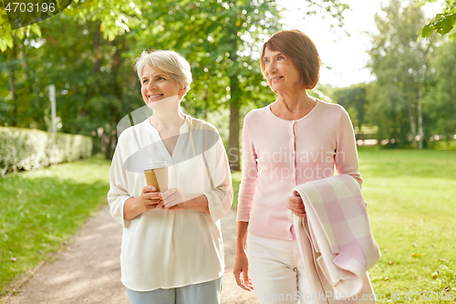 Image of senior women or friends drinking coffee at park