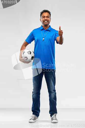 Image of football fan with soccer ball showing thumbs up