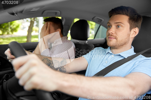 Image of car driving school instructor and male driver