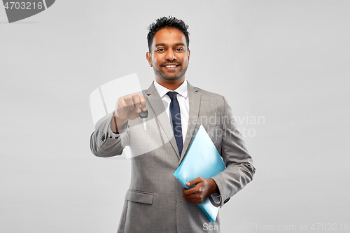 Image of happy indian man showing car key