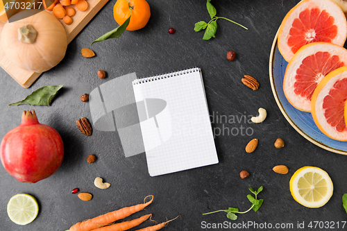 Image of close up of notebook, fruits and vegetables