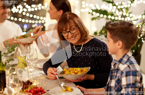 Image of happy family having dinner party at home
