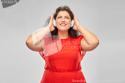 Image of happy woman in headphones listening to music