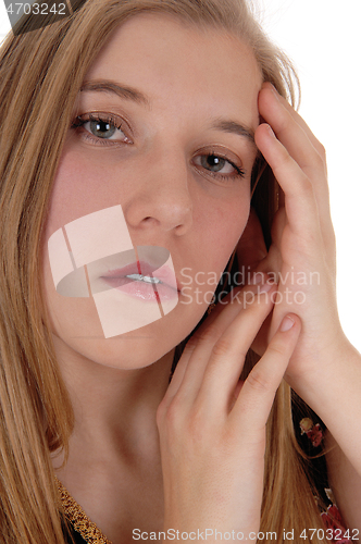 Image of Dreaming woman holding hands on face