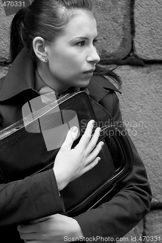 Image of woman in black holding portfolio