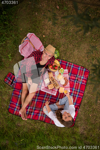 Image of top view of couple enjoying picnic time