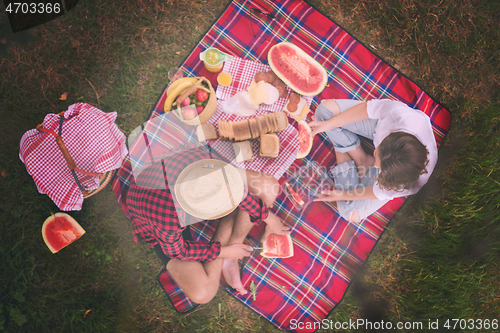 Image of top view of couple enjoying picnic time