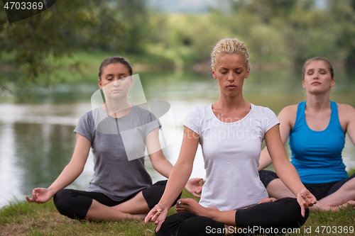 Image of women meditating and doing yoga exercise