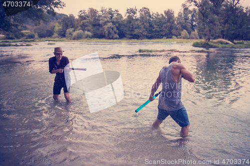 Image of young men having fun with water guns