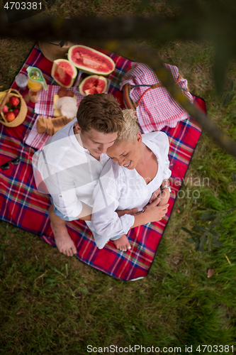 Image of top view of couple enjoying picnic time