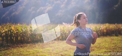 Image of woman jogging along a country road