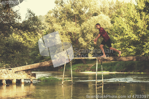 Image of man jumping into the river