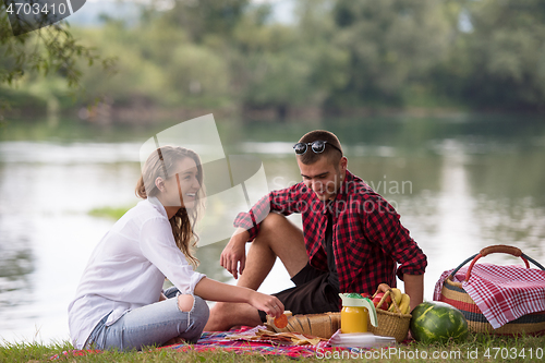 Image of Couple in love enjoying picnic time