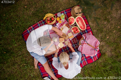 Image of top view of couple enjoying picnic time