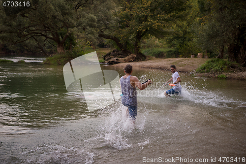 Image of young men having fun with water guns