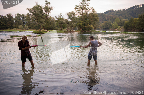 Image of young men having fun with water guns