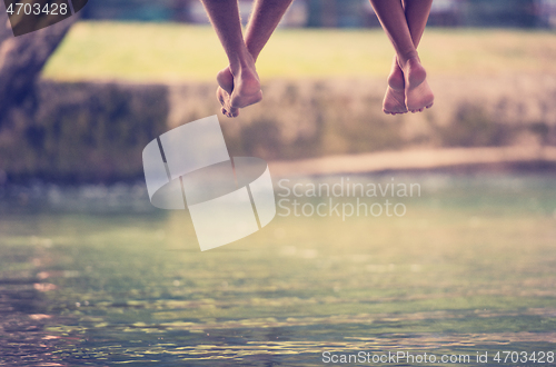 Image of people sitting at wooden bridge