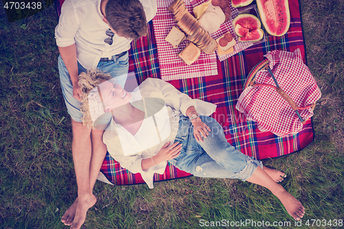 Image of top view of couple enjoying picnic time