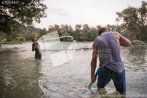 Image of young men having fun with water guns