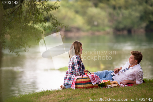 Image of Couple in love enjoying picnic time