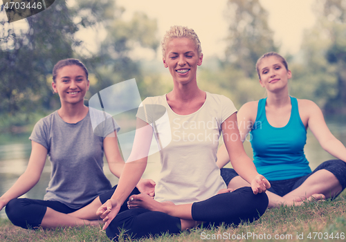 Image of women meditating and doing yoga exercise