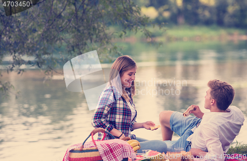 Image of Couple in love enjoying picnic time