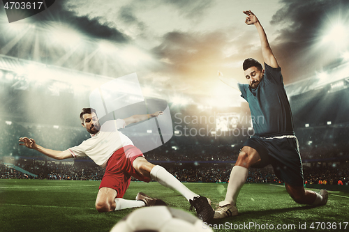 Image of Two men are playing soccer and they compete with each other