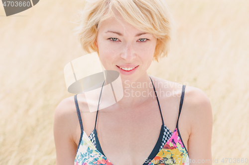 Image of Lady enjoying the nature. Young woman enjoying the fresh air in summer meadow