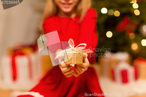 Image of close up of girl with christmas gift at home