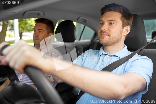 Image of car driving school instructor and male driver