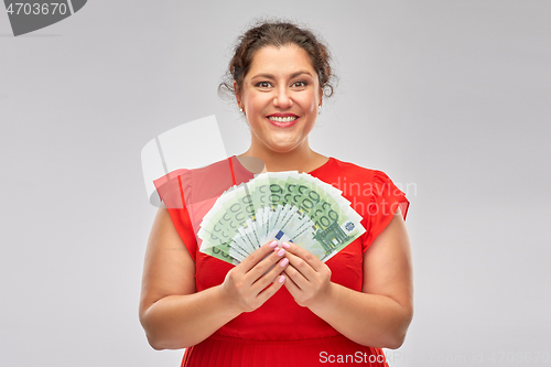 Image of happy woman holding hundreds of money banknotes