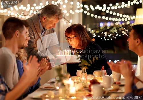 Image of happy family having birthday party at home