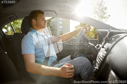 Image of man or driver driving car