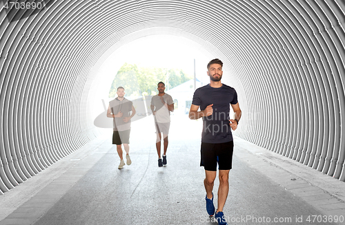 Image of young men or male friends running outdoors