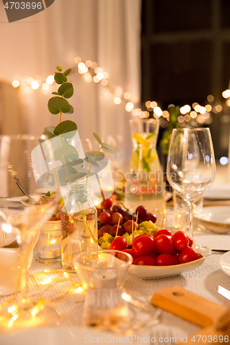 Image of table served with plates, wine glasses and food