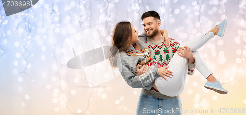 Image of happy couple at christmas ugly sweater party