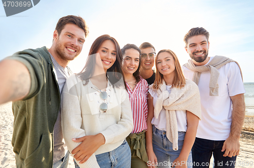 Image of happy friends taking selfie on summer beach