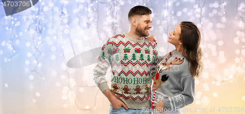 Image of happy couple at christmas ugly sweater party