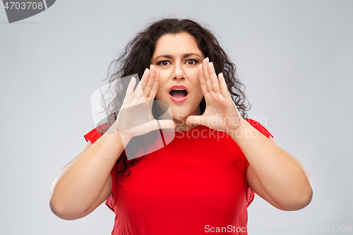 Image of worried woman in red dress calling