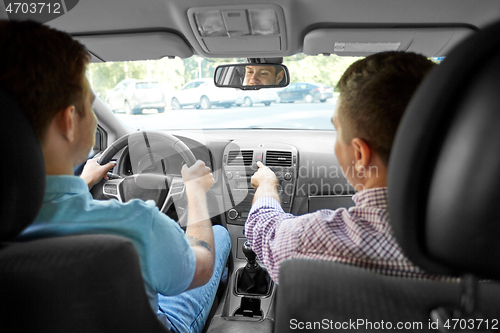 Image of car driving school instructor teaching male driver