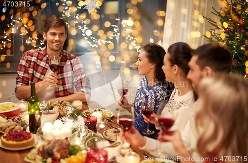 Image of friends celebrating christmas and speaking toast