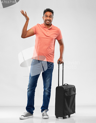 Image of indian man in polo shirt with travel bag shrugging