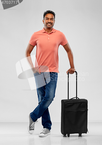 Image of smiling indian man in polo shirt with travel bag