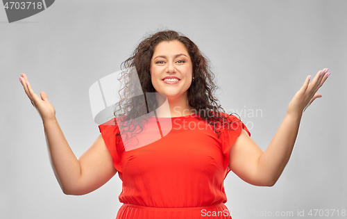 Image of happy smiling woman in red dress looking up