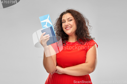 Image of happy woman with passport and air ticket