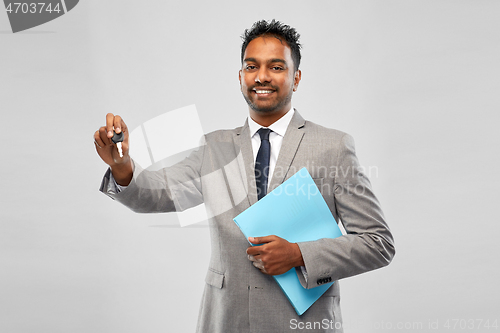 Image of happy indian man showing car key