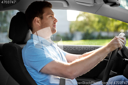 Image of smiling man or driver driving car